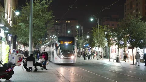 Approaching Light Rail Train with Late Night Shoppers Stock Footage 57173138