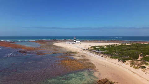 Approaching Lighthouse with Beach and Coastal Landscape on Sunny Day Stock Footage 306285599