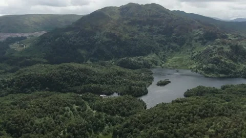 Approaching Loch Katrine in Scotland. A ship reveals in the background  Stock Footage