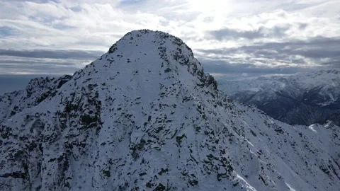 Approaching the mountain peak with cross in winter, landscape with snow, Alps 4K Stock Footage 148031170