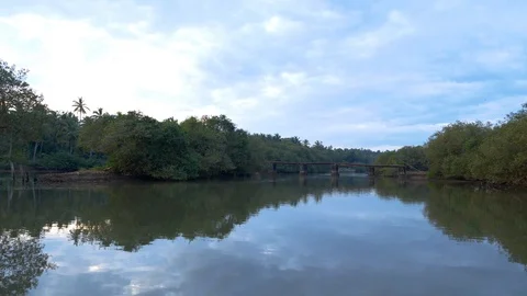 Approaching an old cement bridge while travelling in a boat, Kerala, India Stock Footage 120836346