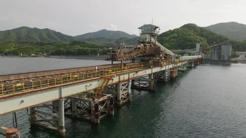 Approaching pier with old rusty conveyor belt for loading bulk materials Stock Footage 244934413