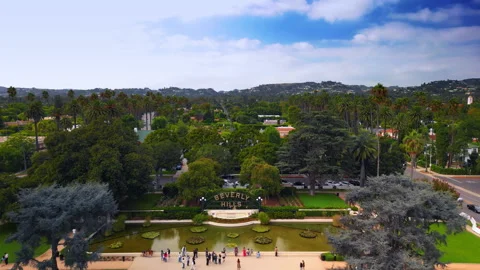 Approaching the pond with Beverly Hills sign in the beautiful park. Stock Footage 318313712