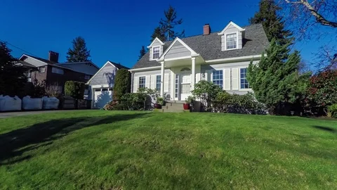 Approaching a quaint American Cape Cod style home Stock Footage 94185163