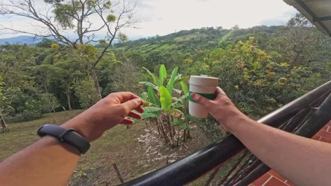 Approaching the Railing and Holding Reusable Coffee Cup. 動画素材 329528896