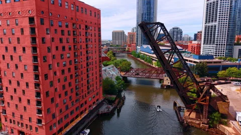 Approaching the red multi-storied building at the waterfront of the Chicago Stock Footage 336338527