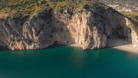 Approaching to secluded beach and grotto in steep cliff above blue sea. Palinuro Stockbeeldmateriaal 102456498