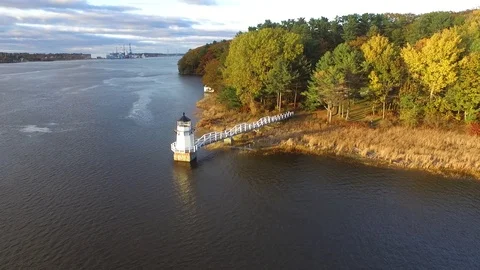 Approaching a Small Riverside Lighthouse From Above Video stock 97545189