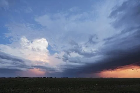 Approaching storm clouds with lightning in Nebraska, a blue sky background,.. Stock Photos
