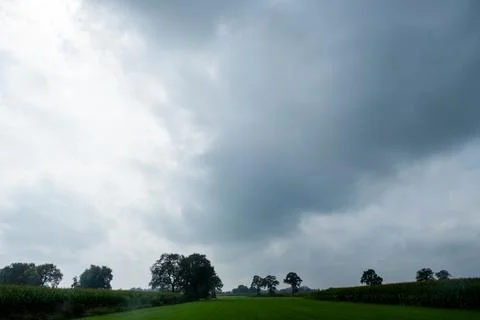 Approaching Storm Over Tranquil Fields Stock Photos