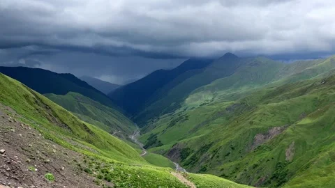 Approaching Storm Over Verdant Mountain Valley Video stock 260207036