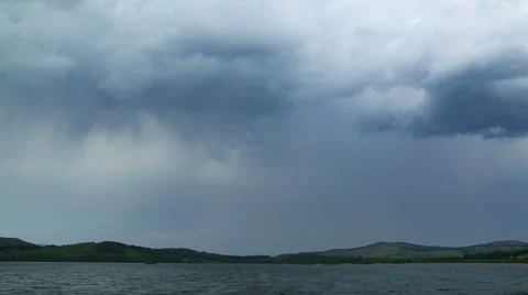 Approaching storm - storm clouds over lake - timelapse Stock Footage