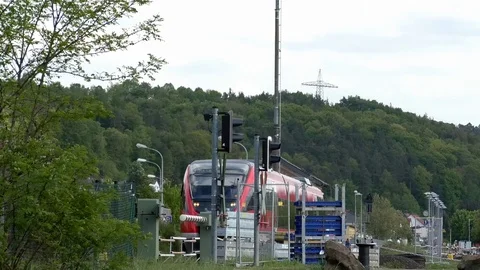 Approaching train passing by railroad crossing with gates, barriers opening Video stock 89306808