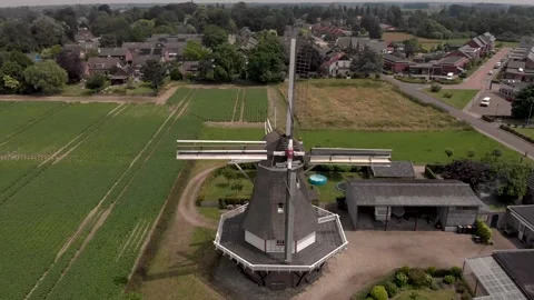 Approaching typical Dutch windmill with wicks in countryside of The Stock Footage 157464460