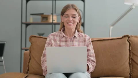 Approval Gesture by Young Woman Using Laptop while Sitting on Sofa 스톡 동영상 287922381