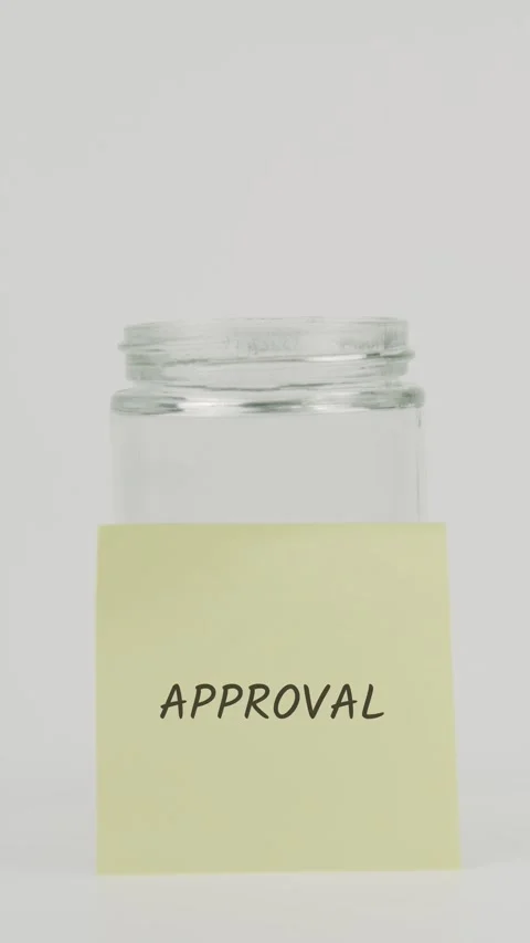 Approval text or word on yellow sticky note attached to glass jar with hand Stock Footage 311677890