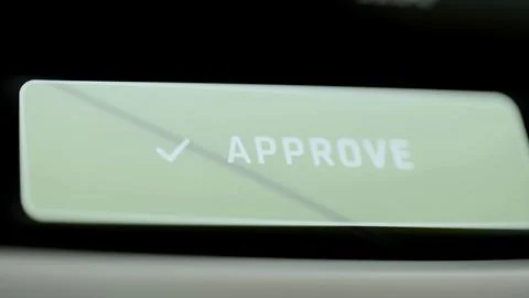 Approve button rests on dark console Fotos Stock