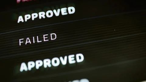 Approved and failed labels on dark payment list Stock Photos