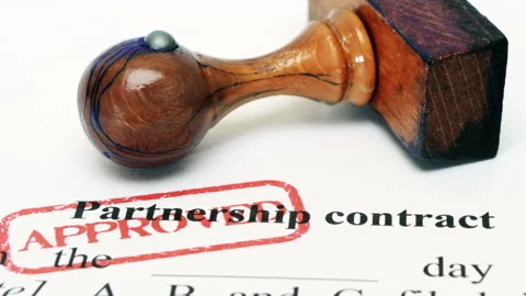 Approved Partnership Contract Document with Wooden Stamp Close-Up Stock Footage 335416499