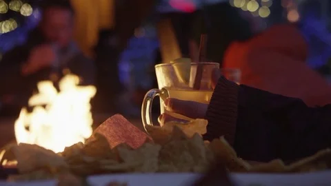 Apres Ski on Patio in front of Firepit with Chips and Hot Drink 動画素材 83359961