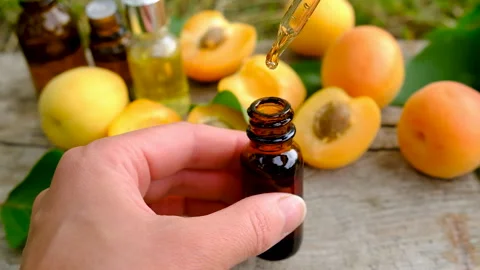Apricot essential oil in a bottle. Selective focus. Stock Footage 317908844