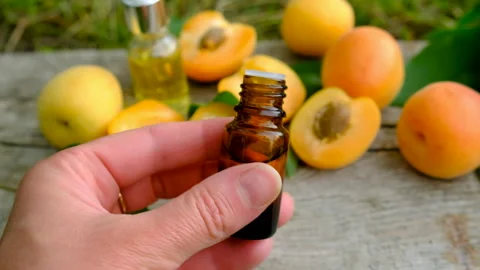 Apricot essential oil in a bottle. Selective focus. Stock Footage 317909341