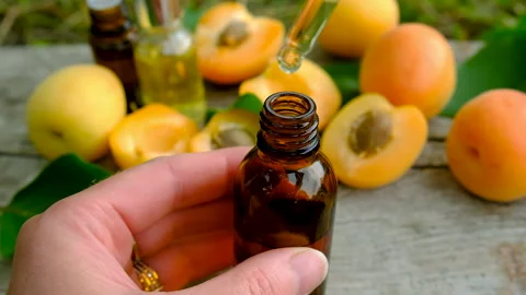 Apricot essential oil in a bottle. Selective focus. Stock Footage 317909433