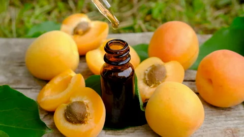 Apricot essential oil in a bottle. Selective focus. Stock Footage 317909716