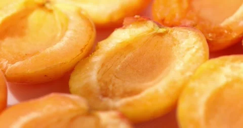 Apricot halves on a cutting board. Close-up. Dolly shot. Stock Footage 247539980