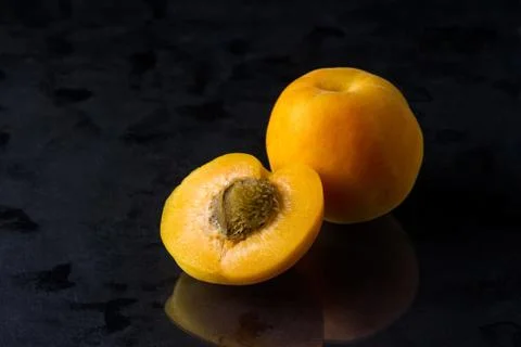 Apricots on a black background. Stock Photos