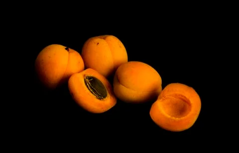 Apricots on black backround Stock Photos