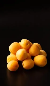 Apricots on black reflective background Stock Photos