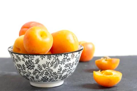 Apricots in bowl on table Stock Photos