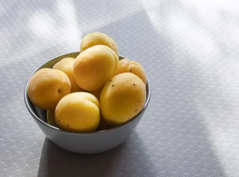 Apricots in a cup on the table. Stock Photos