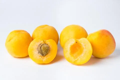 Apricots on a white background. Front two slices of apricot. Stock Photos