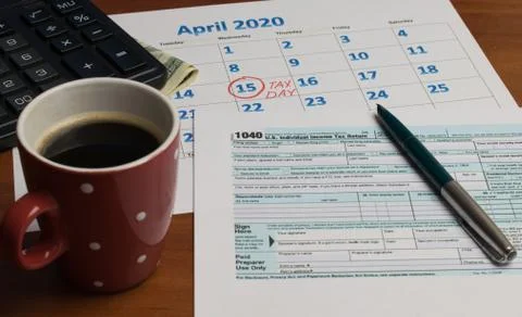 April 15 National Tax Day	coffee tax return and pen on the table Stock Photos