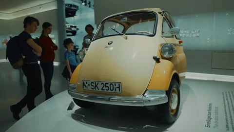 April 20, 2022. Munich, Germany. Visitors admire a vintage BMW Isetta at the BMW Stock Footage 319022401