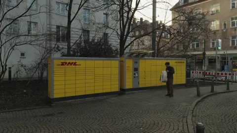 April 25, 2026. Munich, Germany. DHL Packstation, convenient self service parcel Video stock 334201490