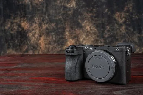 APS-C mirrorless Sony a6700 photo camera on a mahogany table with the backg.. Stock Photos