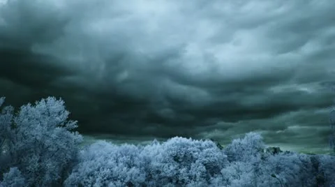 Aqua blue clouds and trees, infrared time lapse t3313C Stock Footage 11409610