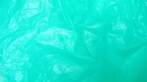 Aqua crumpled plastic bag texture background rotating. HDPE Polyethylene Stock Footage 316377318