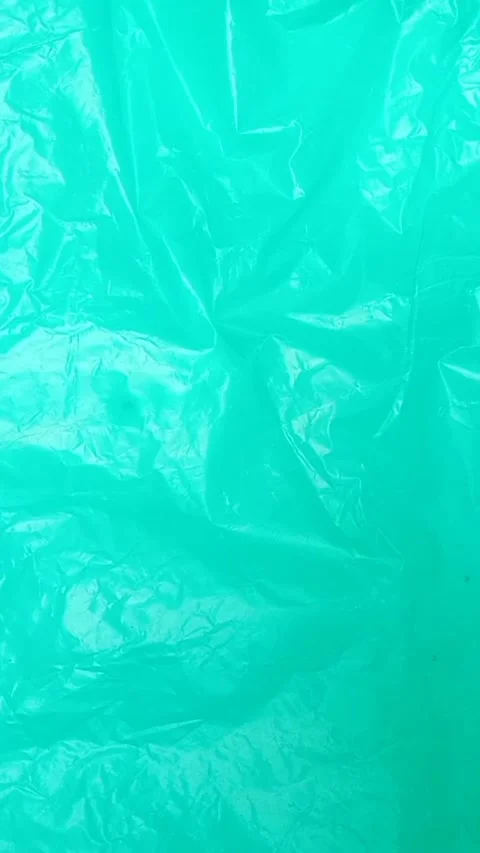 Aqua crumpled plastic bag texture background rotating. HDPE Polyethylene Stock Footage 316377533