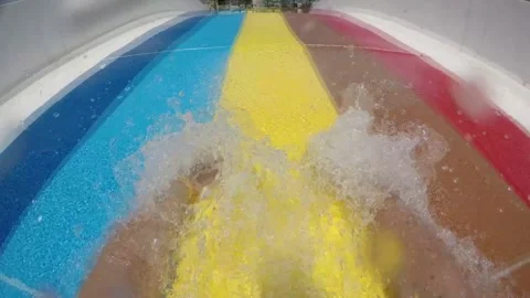 Aquapark gliding style, child sliding down a slide Stock Footage