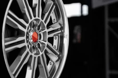 Ar drives in the store with black background. Chrome car wheels for sale. Stock Photos