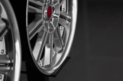 Ar drives in the store with black background. Chrome car wheels for sale. Stock Photos