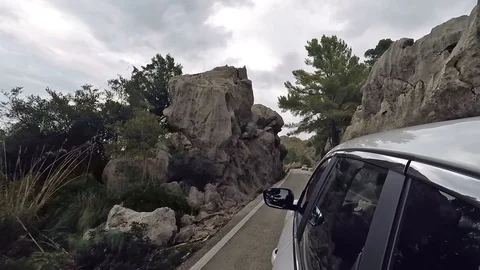 Ar mountain drive - POV view from the the car through a winding mountain road Stock Footage 102369243
