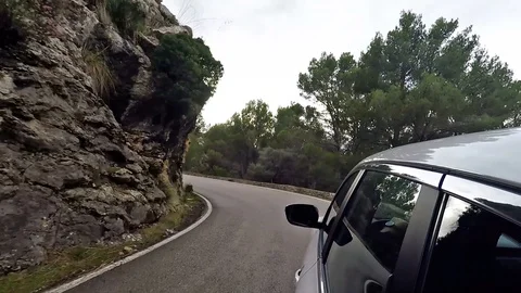 Ar mountain drive - POV view from the the car through a winding mountain road Stock Footage 102371765