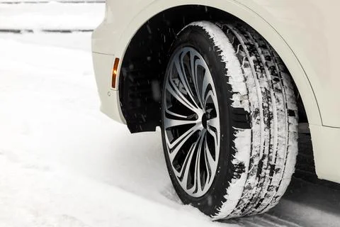 ?ar wheel with an alloy disc and new summer  tires on a car in the winter sea Stock Photos