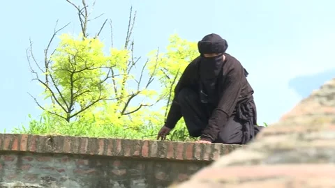 Arab assassin sneaks Stock Footage 140598578