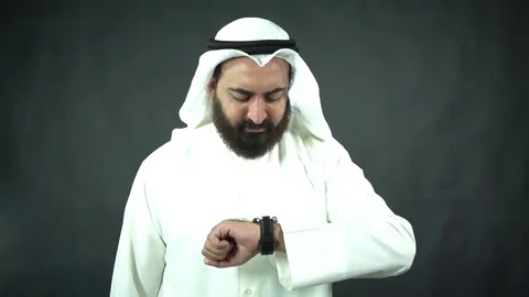 Arab businessman with beard checking time and looking around Stock Footage 134373976